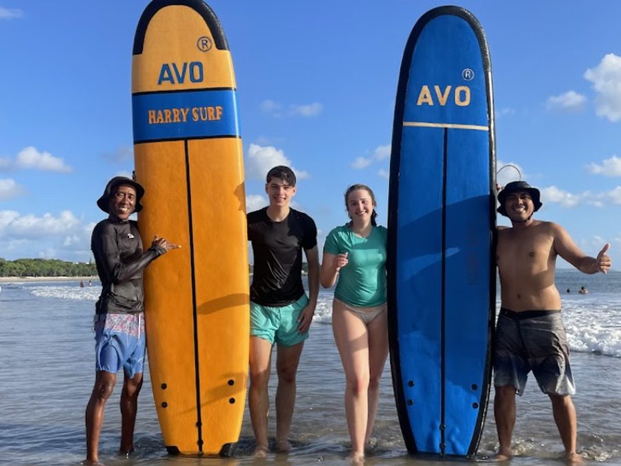 Happy guests with Harry Surf boards after a lesson